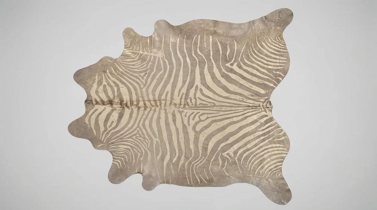 Beige and Grey cowhide rug flat lay on white background showing full hide shape