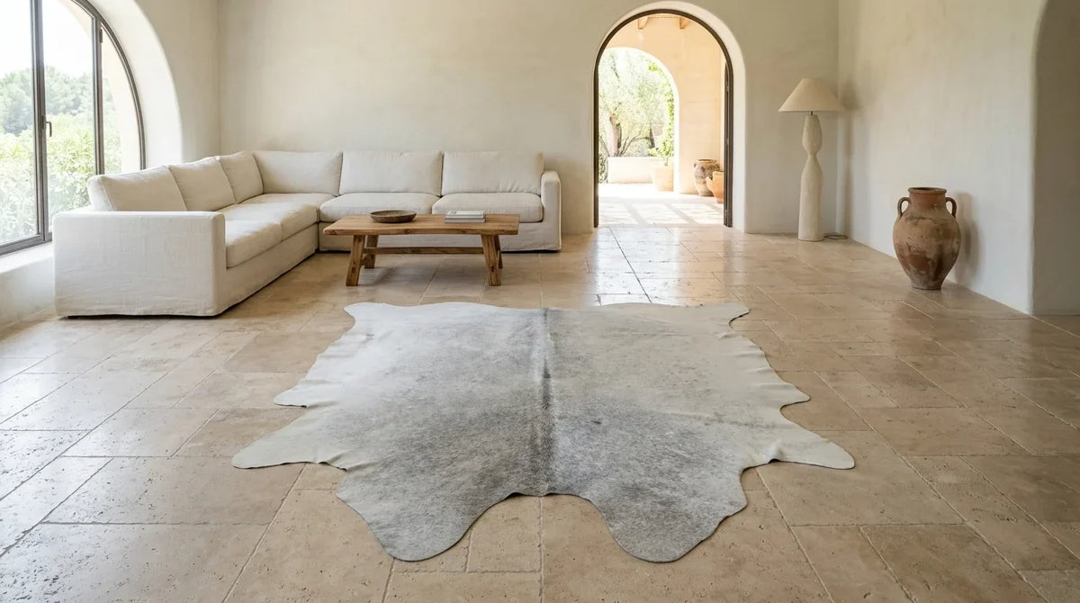 Beige cowhide rug on hardwood floor in organic mediterranean living room