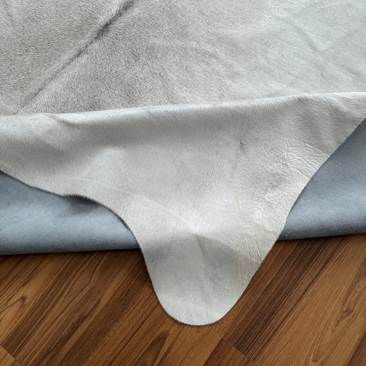 Close-up texture of Beige cowhide rug — Subtle cream and ivory tones with natural hide texture and organic edges