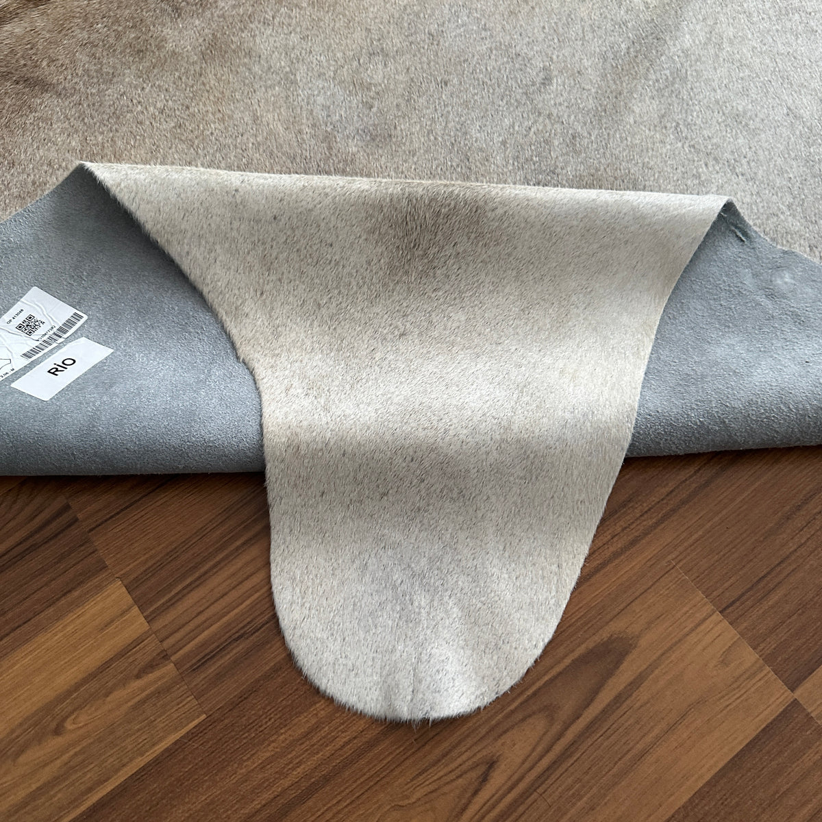 Close-up texture of Beige cowhide rug — Subtle natural markings and grain texture over cream base