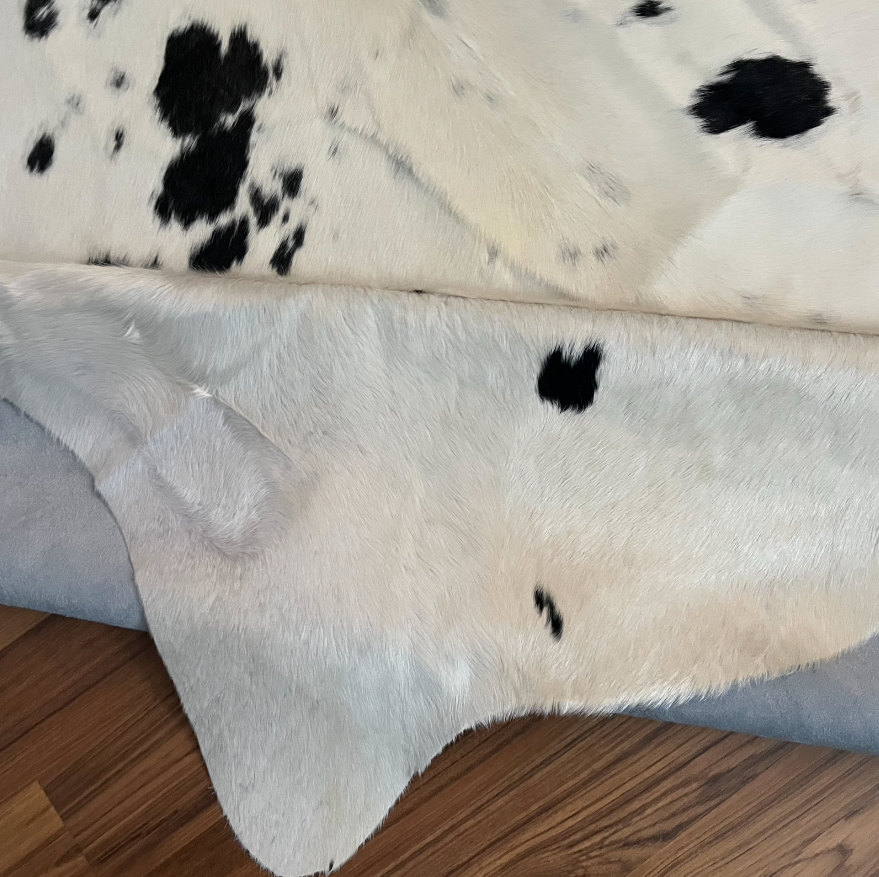 Close-up texture of Black and White cowhide rug — Large irregular black patches scattered over white cream base