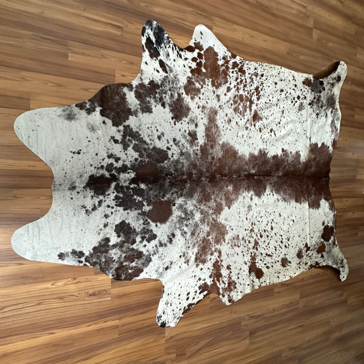 Brown and White cowhide rug, full overhead view