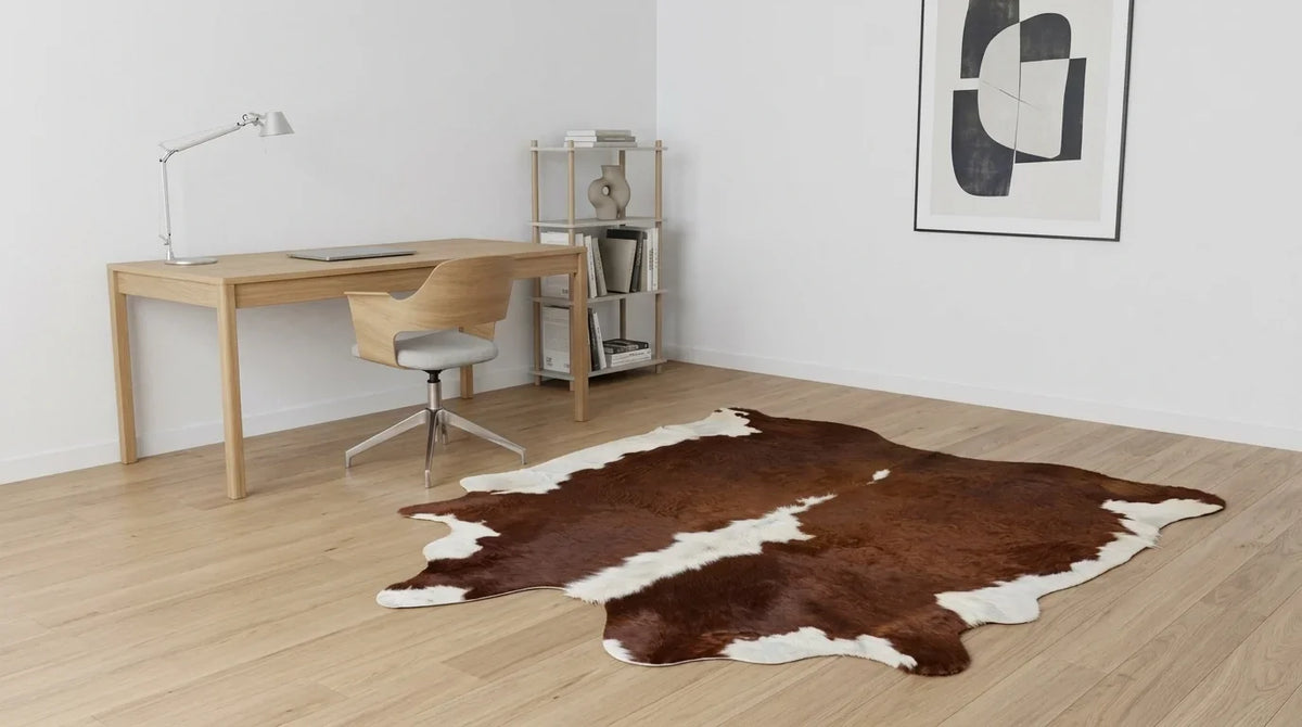 Brown and White cowhide rug under desk in contemporary european home office