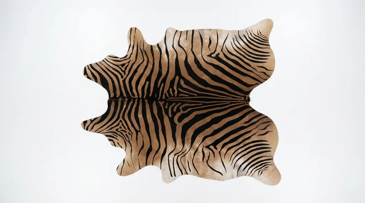Brown and White cowhide rug flat lay on white background showing full hide shape