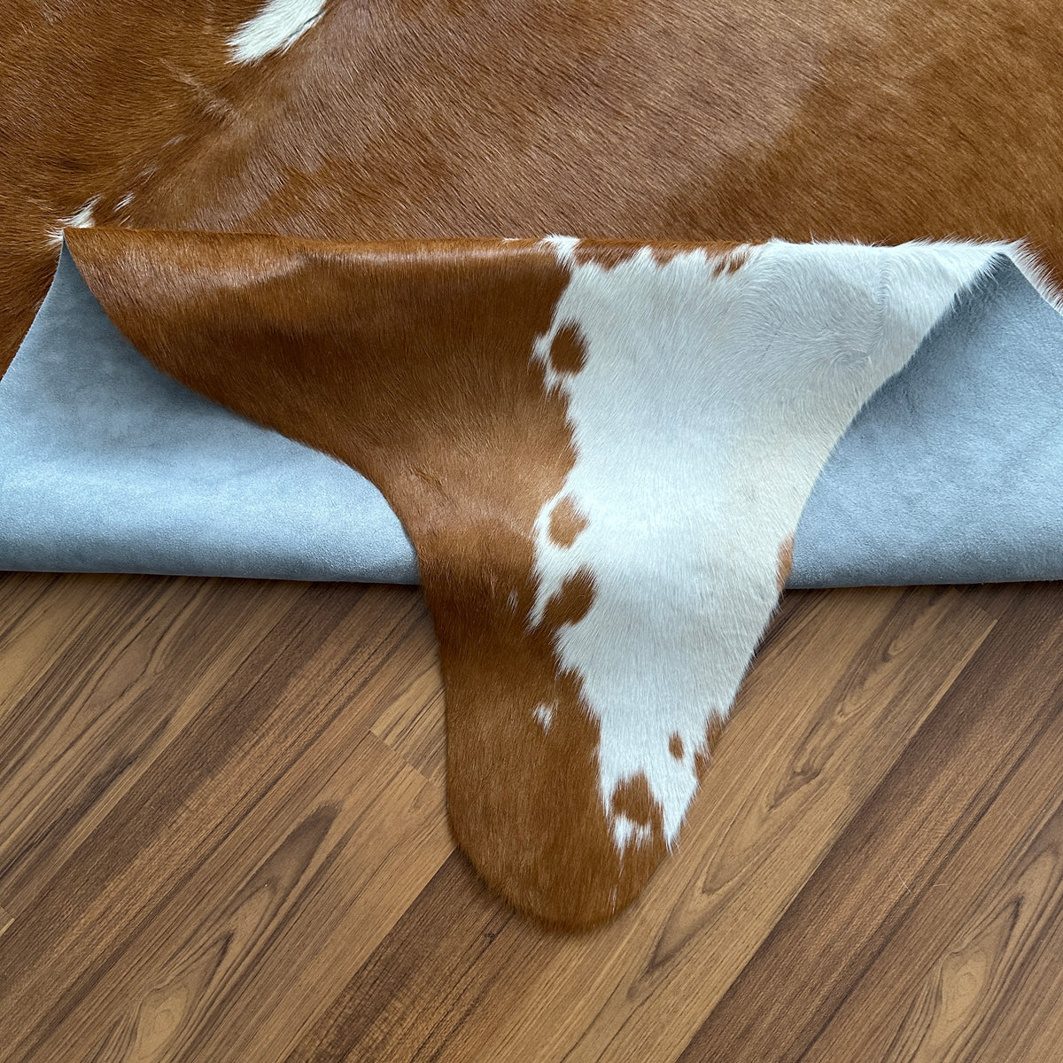 Close-up texture of Brown and White cowhide rug — Large irregular chocolate brown patches over white base with central white