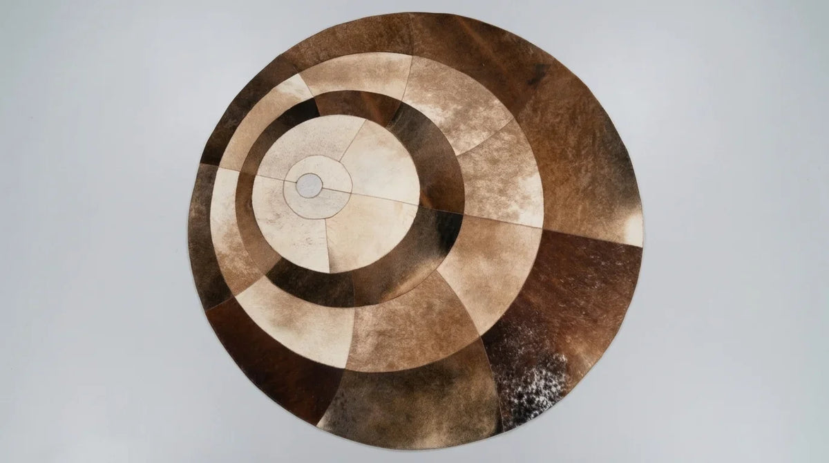 Brown and White round cowhide rug flat lay on white background showing round shape