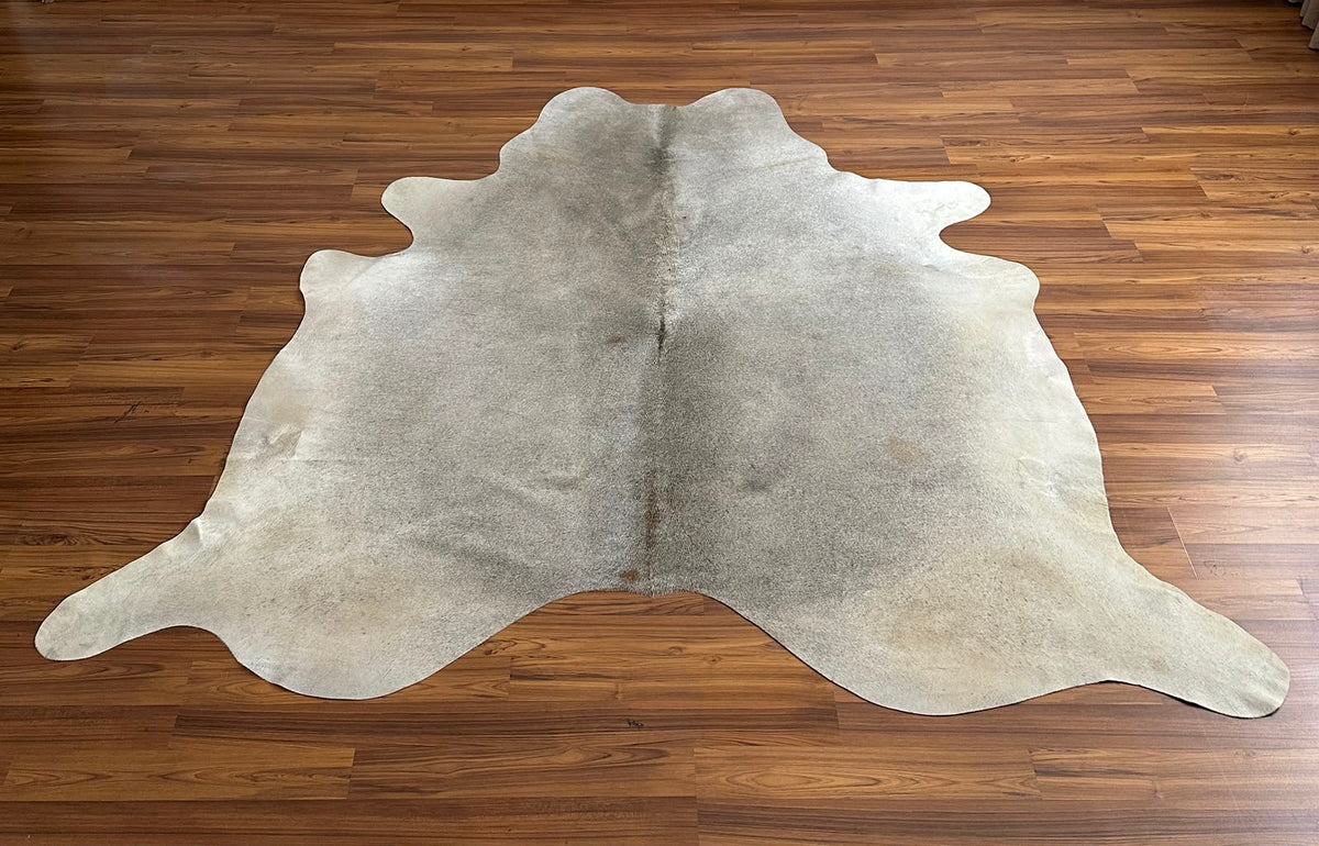 Grey cowhide rug, full overhead view — Fine salt-and-pepper speckle with subtle darker streaking throughout