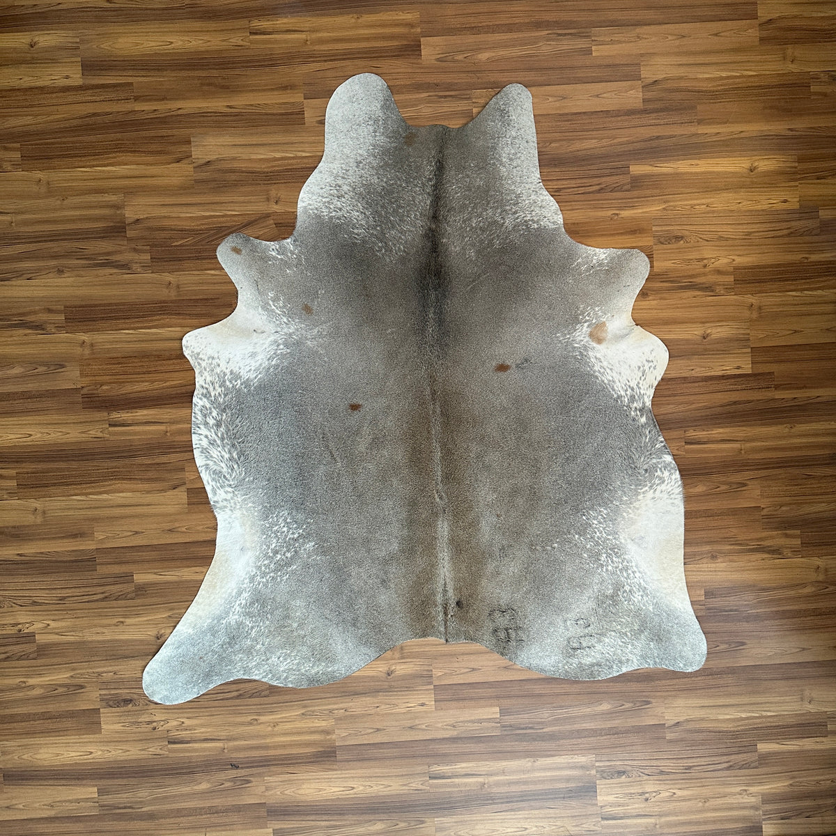 Grey cowhide rug, full overhead view — Fine salt and pepper speckle with natural irregular patches and markings