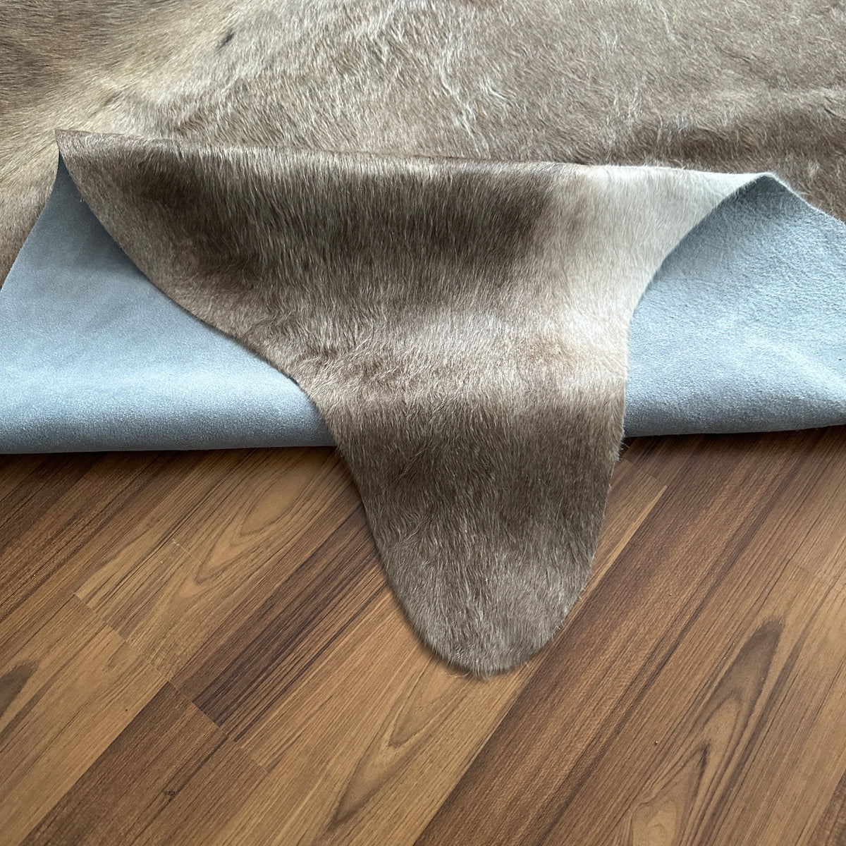 Close-up texture of Grey cowhide rug — Large irregular grey and white patches with natural mottled texture