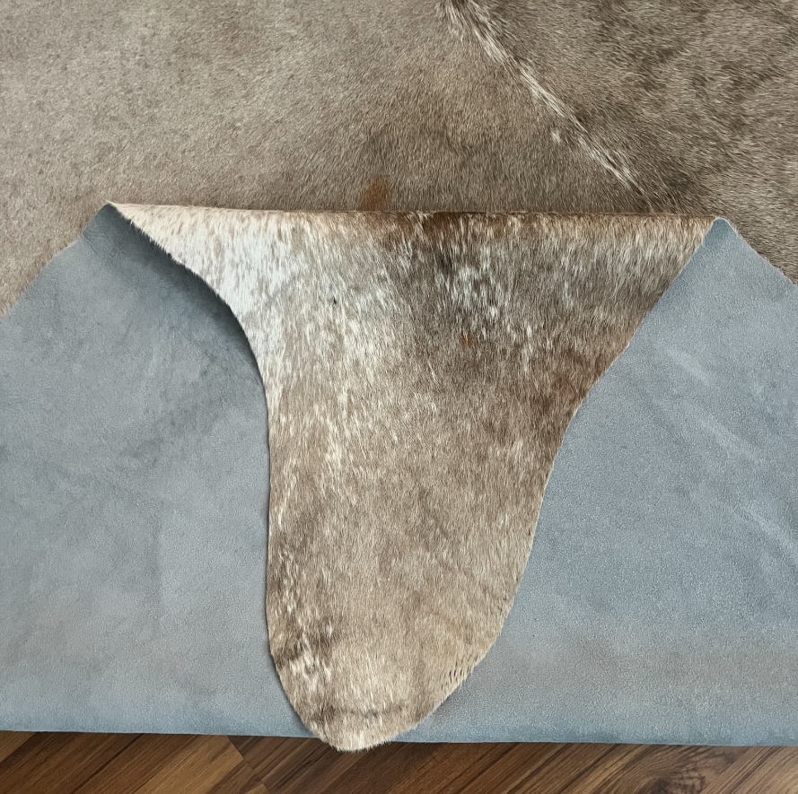 Close-up texture of Grey cowhide rug — Fine salt and pepper texture with subtle darker mottling throughout
