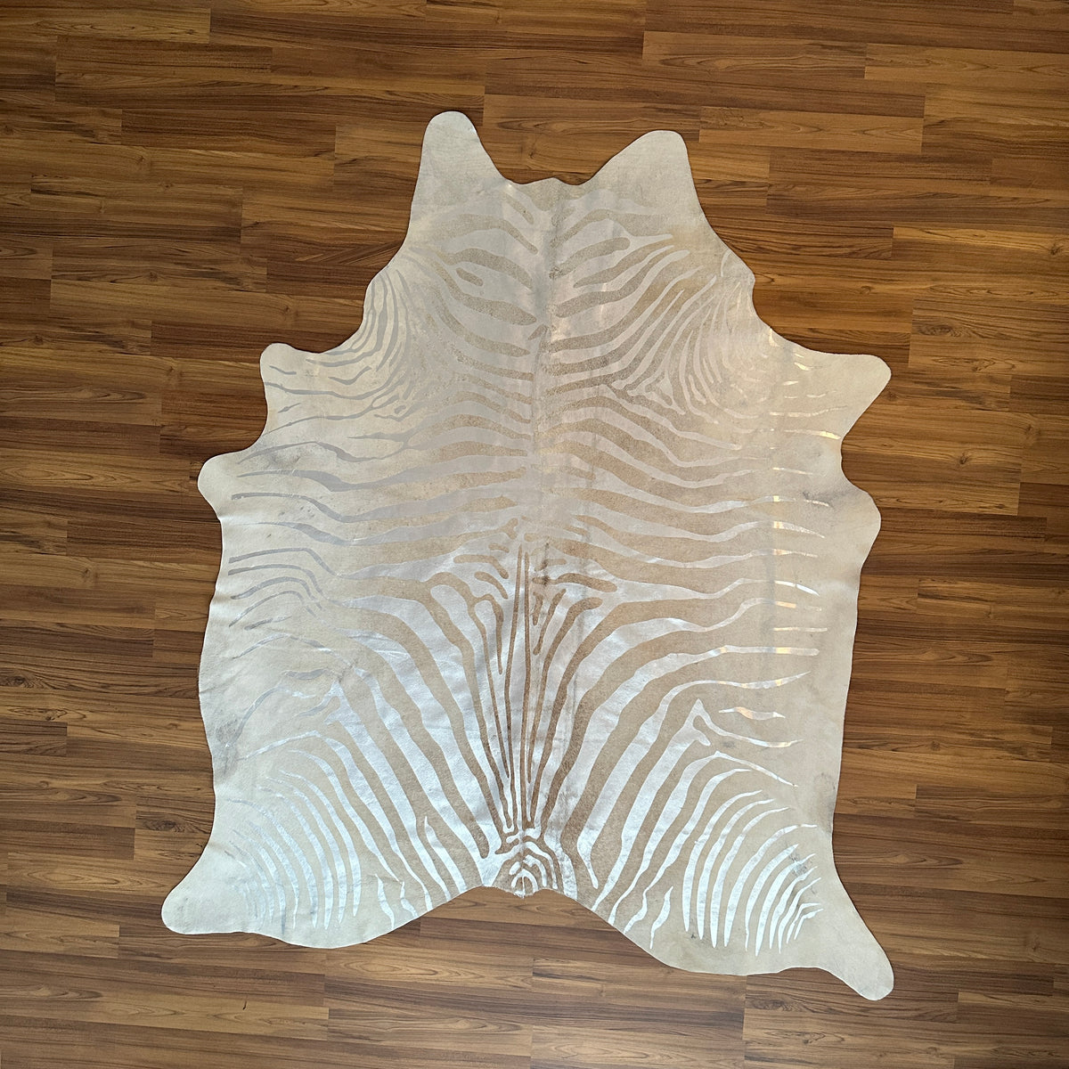 Beige and White zebra print cowhide rug, full overhead view — Bold zebra stripes radiating from center in cream and taupe ton