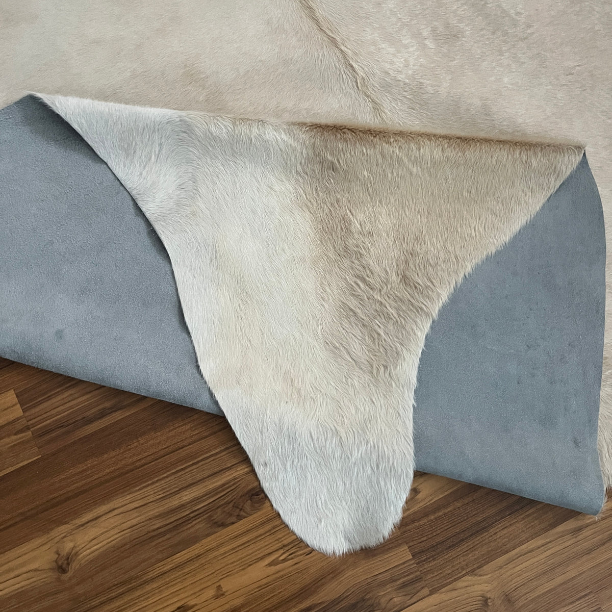 Close-up texture of Beige cowhide rug — Uniformly light cream base with minimal natural variation