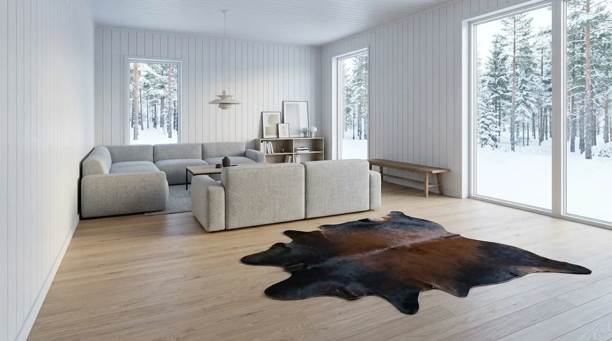 Black and White cowhide rug on hardwood floor in scandinavian cabin living room