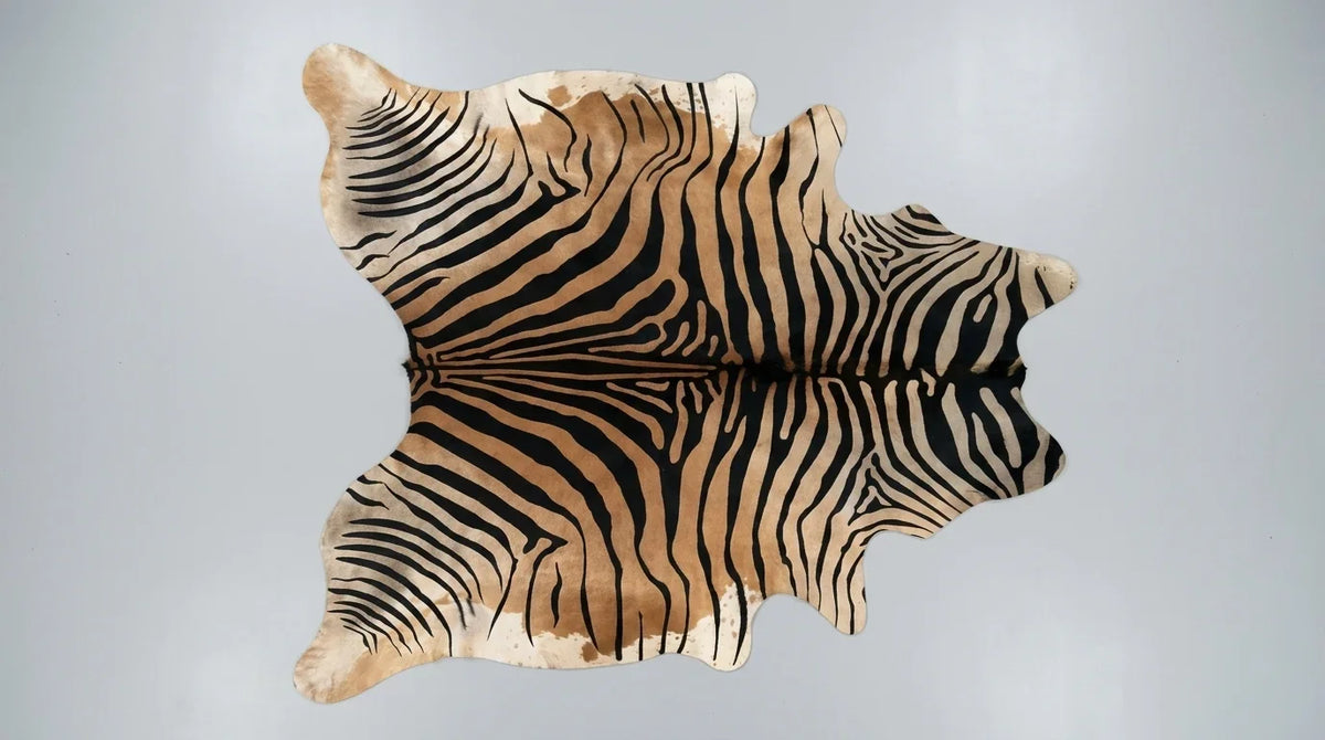 Black and White cowhide rug flat lay on white background showing full hide shape
