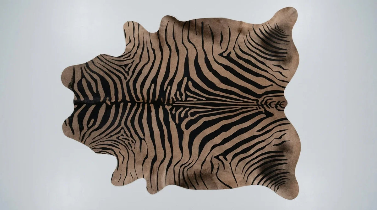 Black and White cowhide rug flat lay on white background showing full hide shape