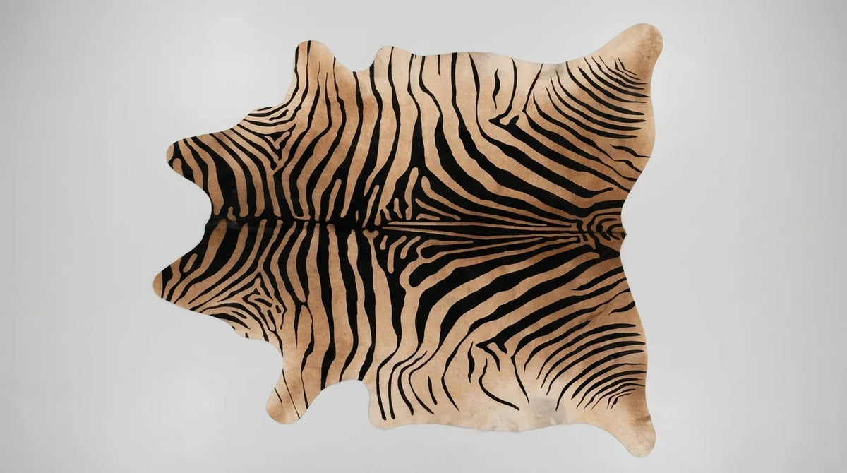 Black and White cowhide rug flat lay on white background showing full hide shape