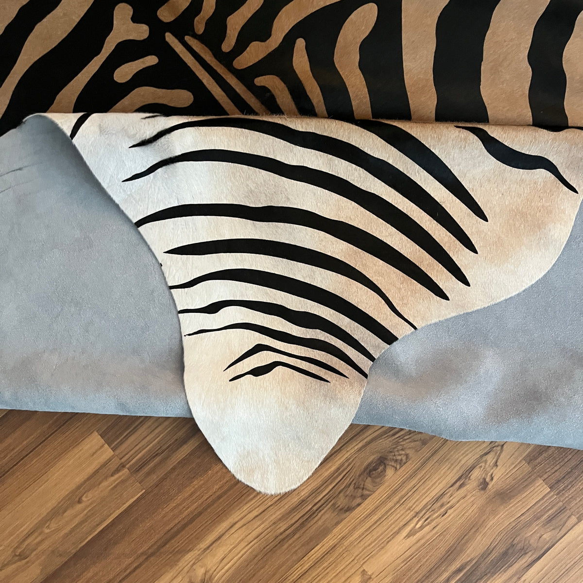 Close-up texture of Black and White zebra print cowhide rug — Bold black stripes radiating from center over white base