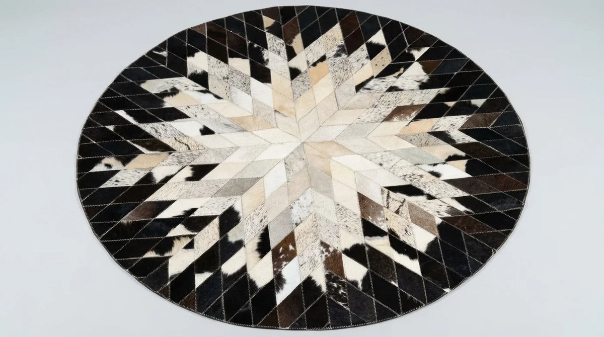 Black and White round cowhide rug flat lay on white background showing round shape