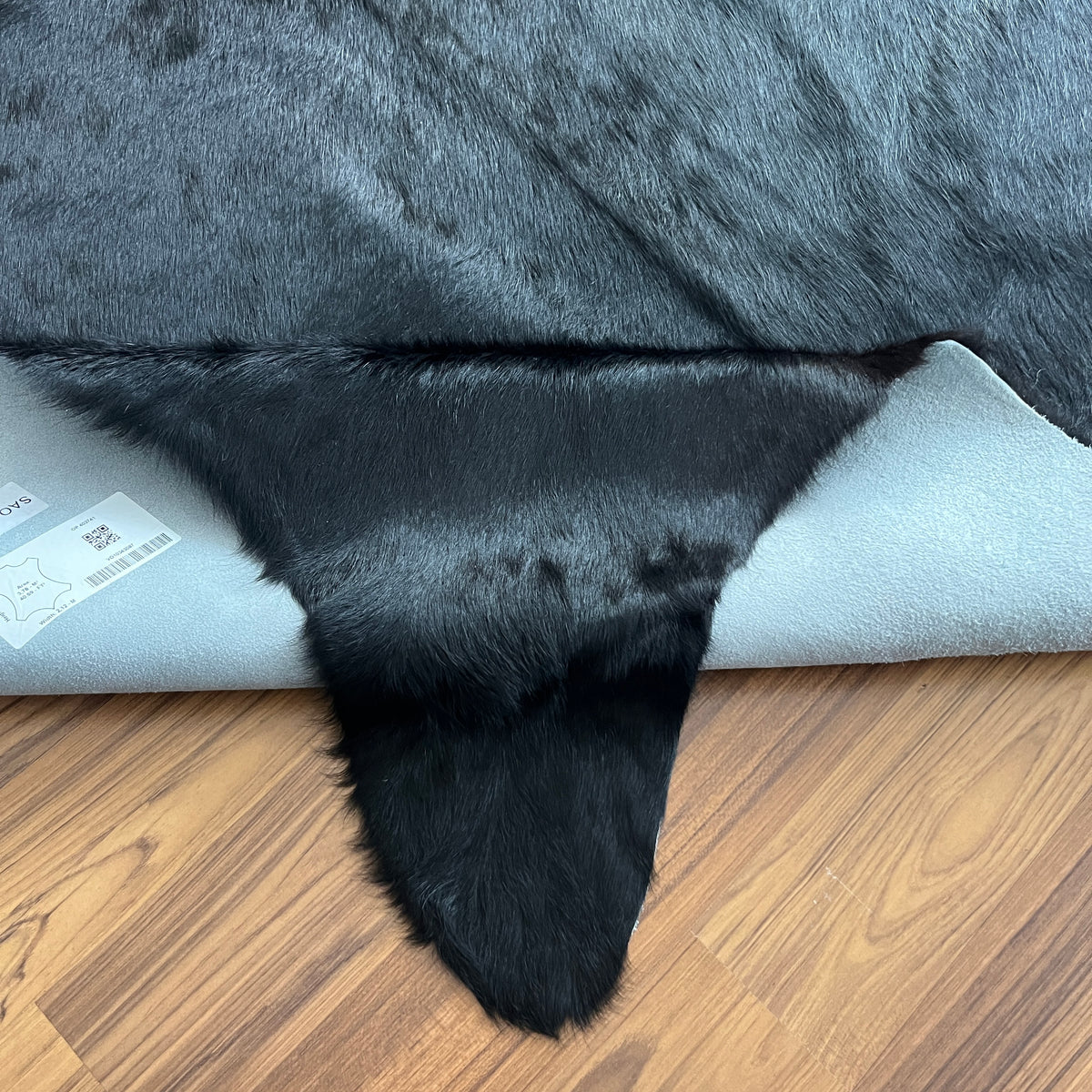 Close-up texture of Black solid black cowhide rug — Uniformly deep black with minimal natural markings