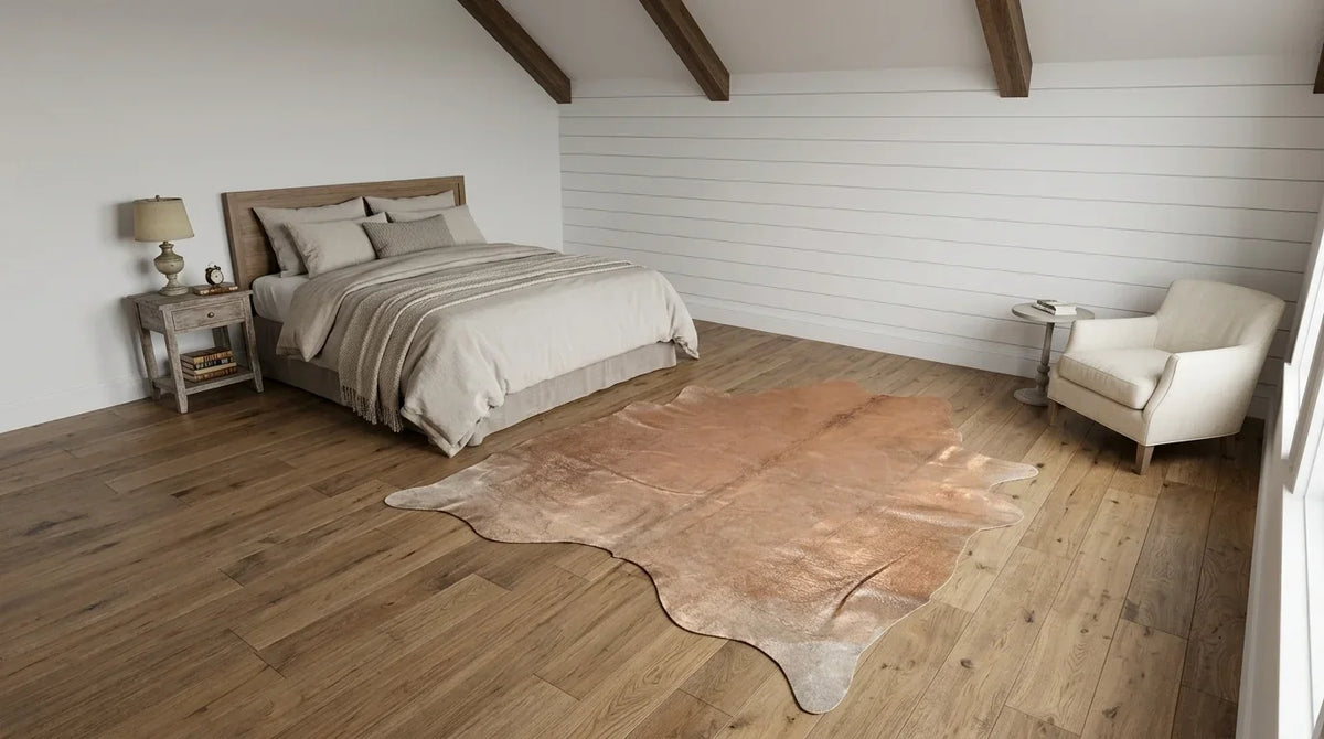 Brown and White cowhide rug beside bed in modern farmhouse bedroom