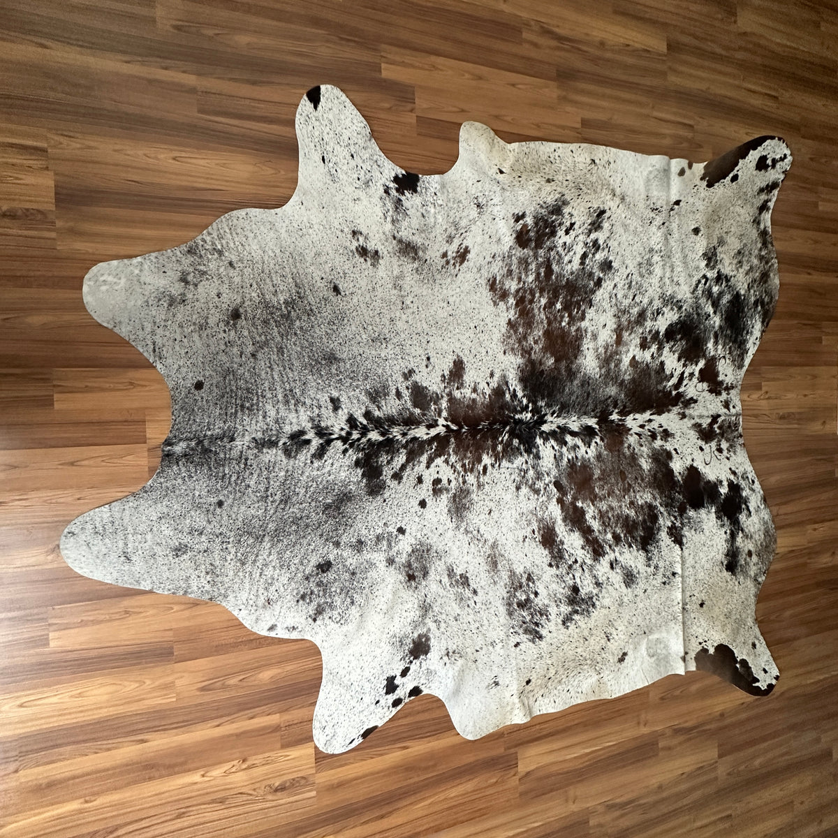 Brown and White cowhide rug, full overhead view