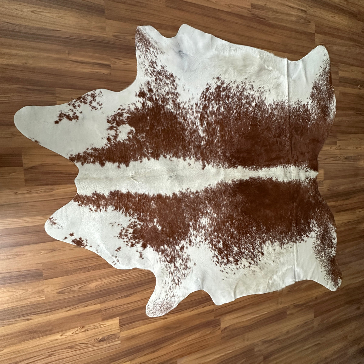 Brown and White cowhide rug, full overhead view
