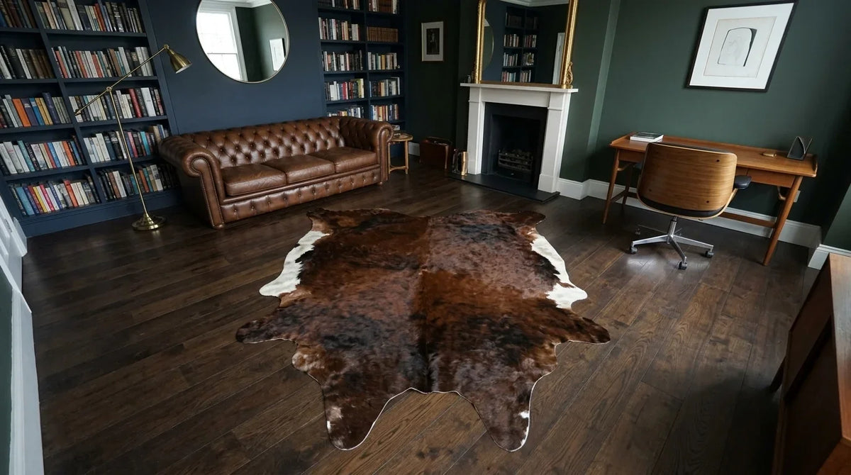 Brown and White cowhide rug under desk in London Townhouse home office
