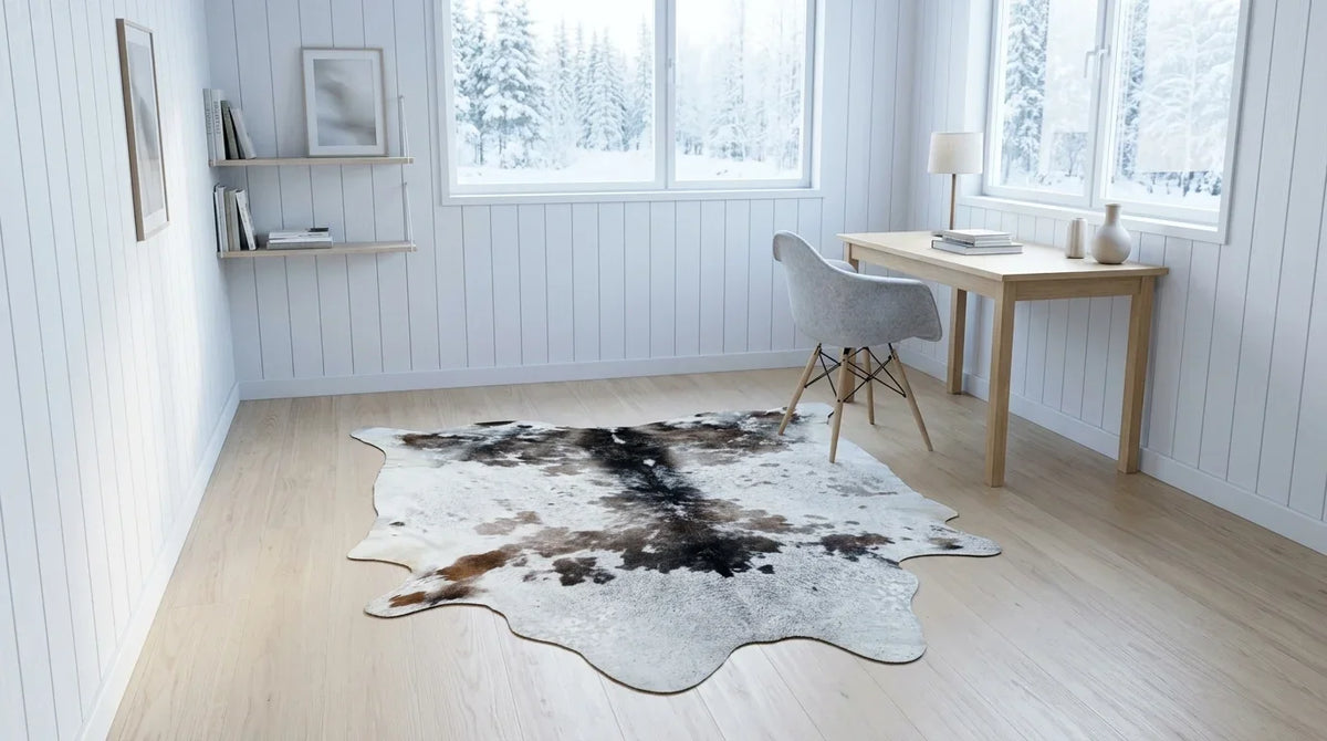 Brown and White cowhide rug under desk in scandinavian cabin home office