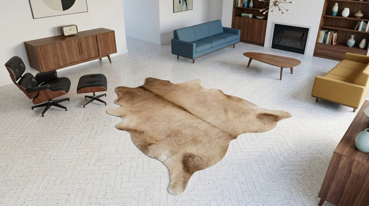 Brown and White cowhide rug on hardwood floor in midcentury modern living room