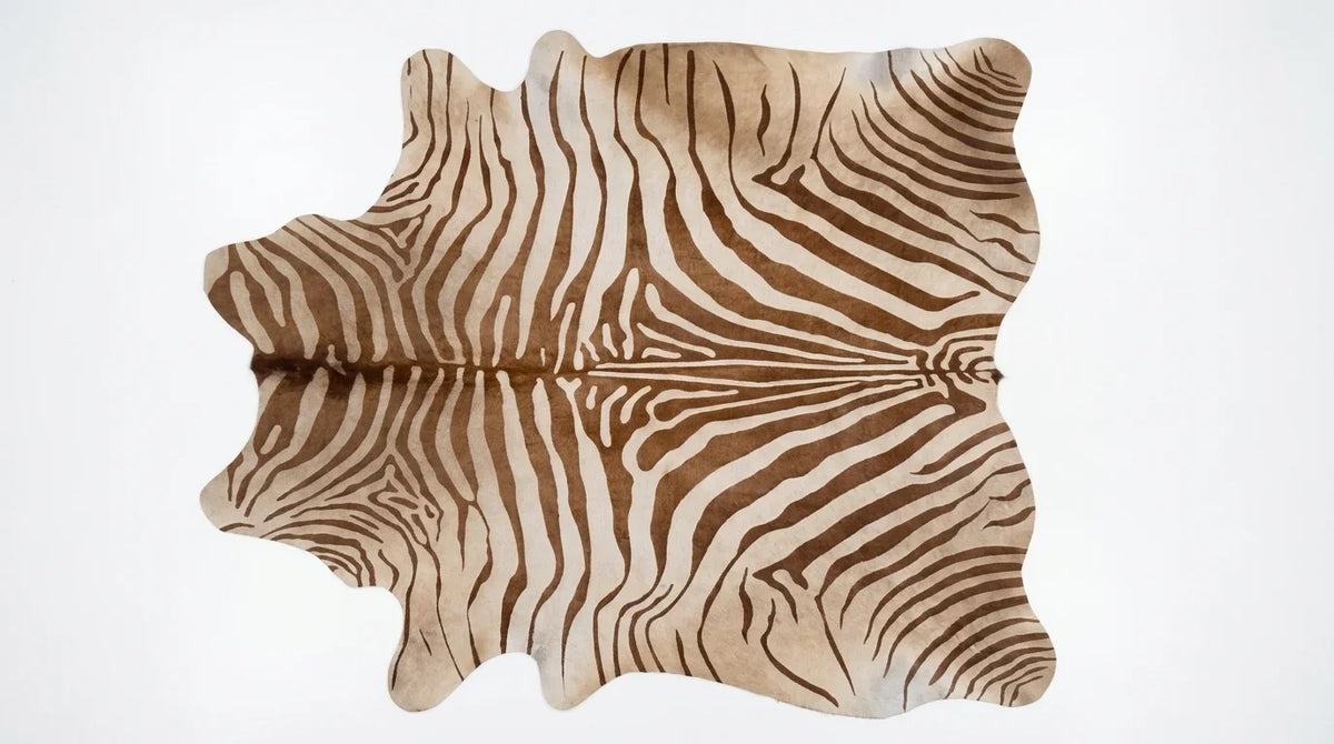Brown and White cowhide rug flat lay on white background showing full hide shape