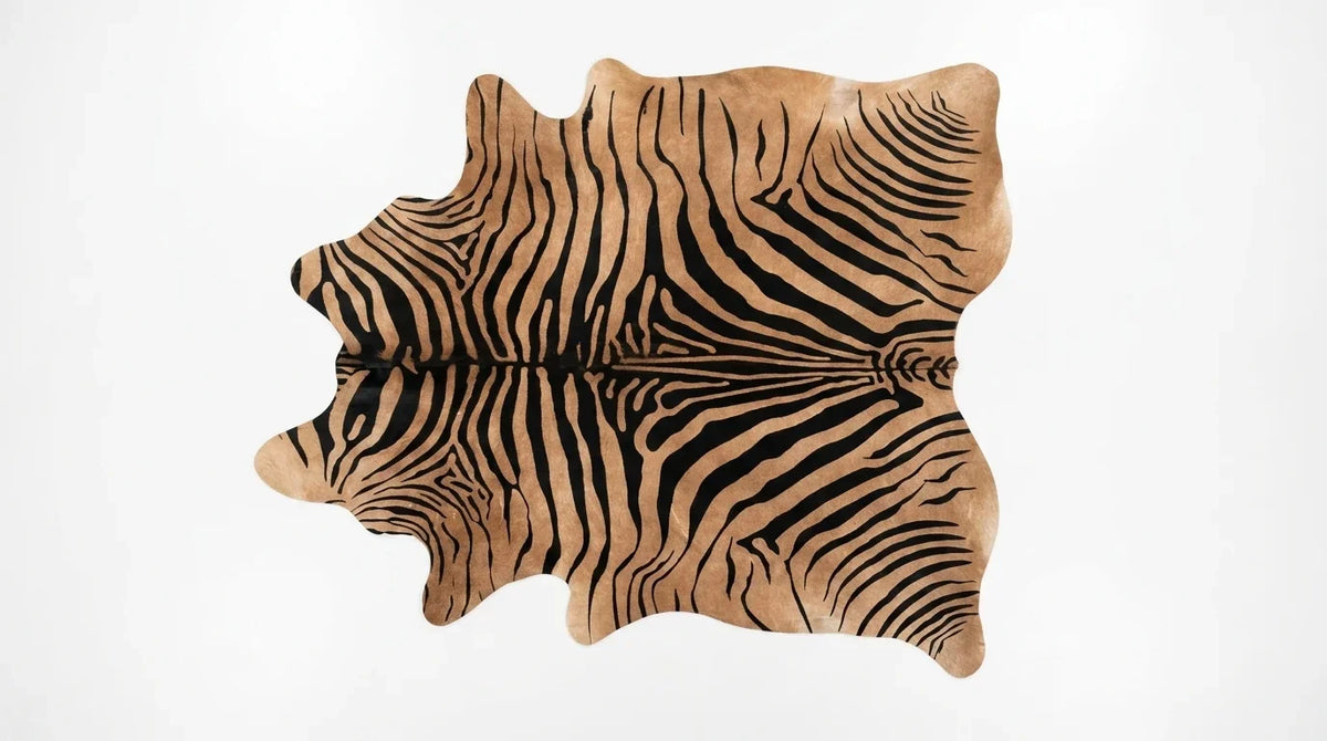 Brown and White cowhide rug flat lay on white background showing full hide shape
