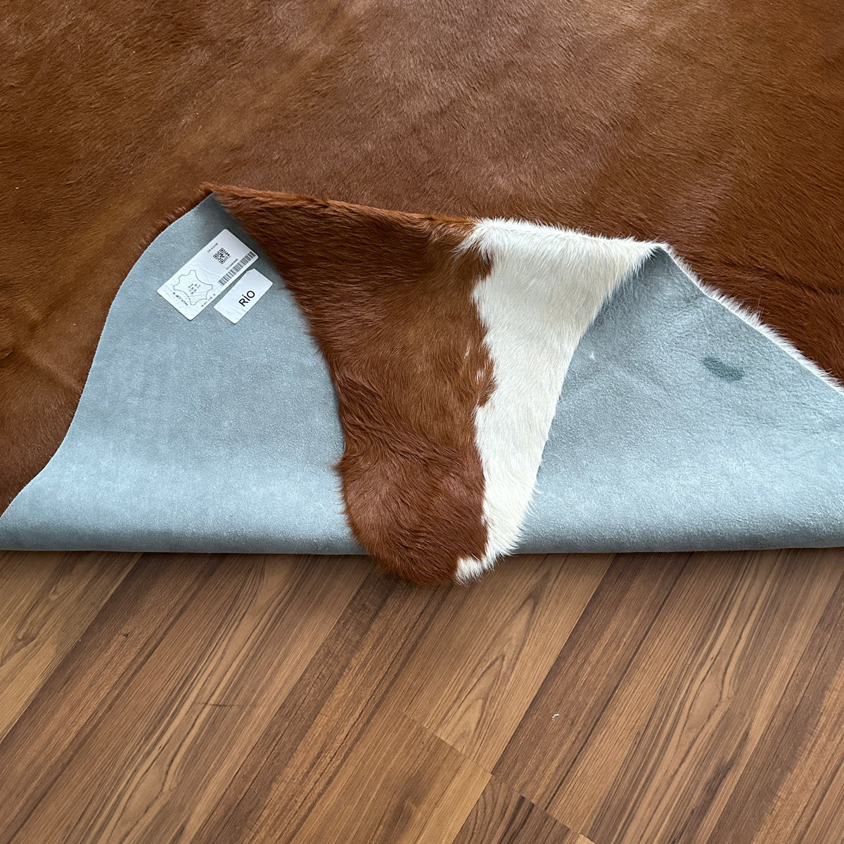Close-up texture of Brown and White cowhide rug — Large irregular chocolate brown patches with cream white markings and natur