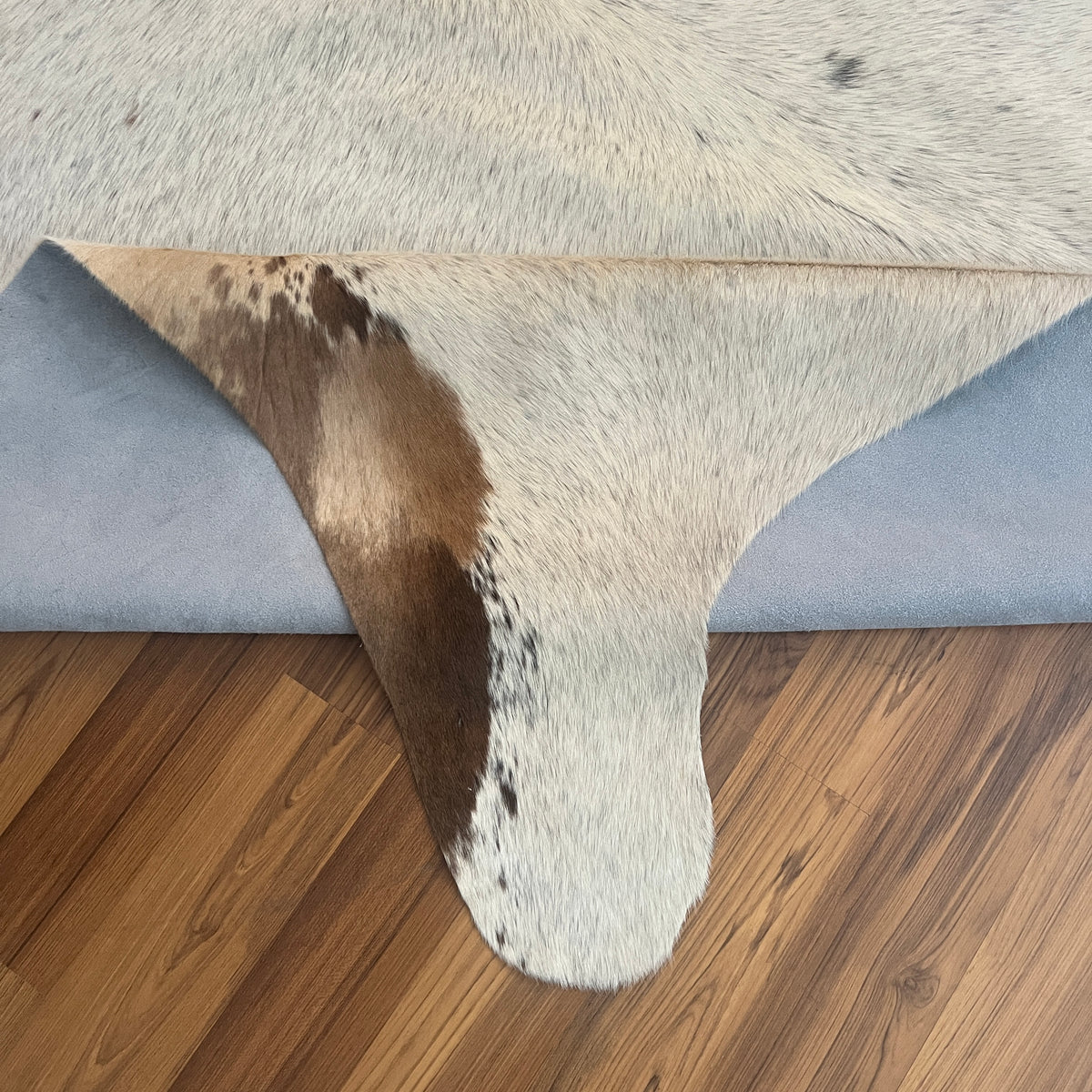 Close-up texture of Brown and White cowhide rug — Large irregular chocolate brown patches over cream white base