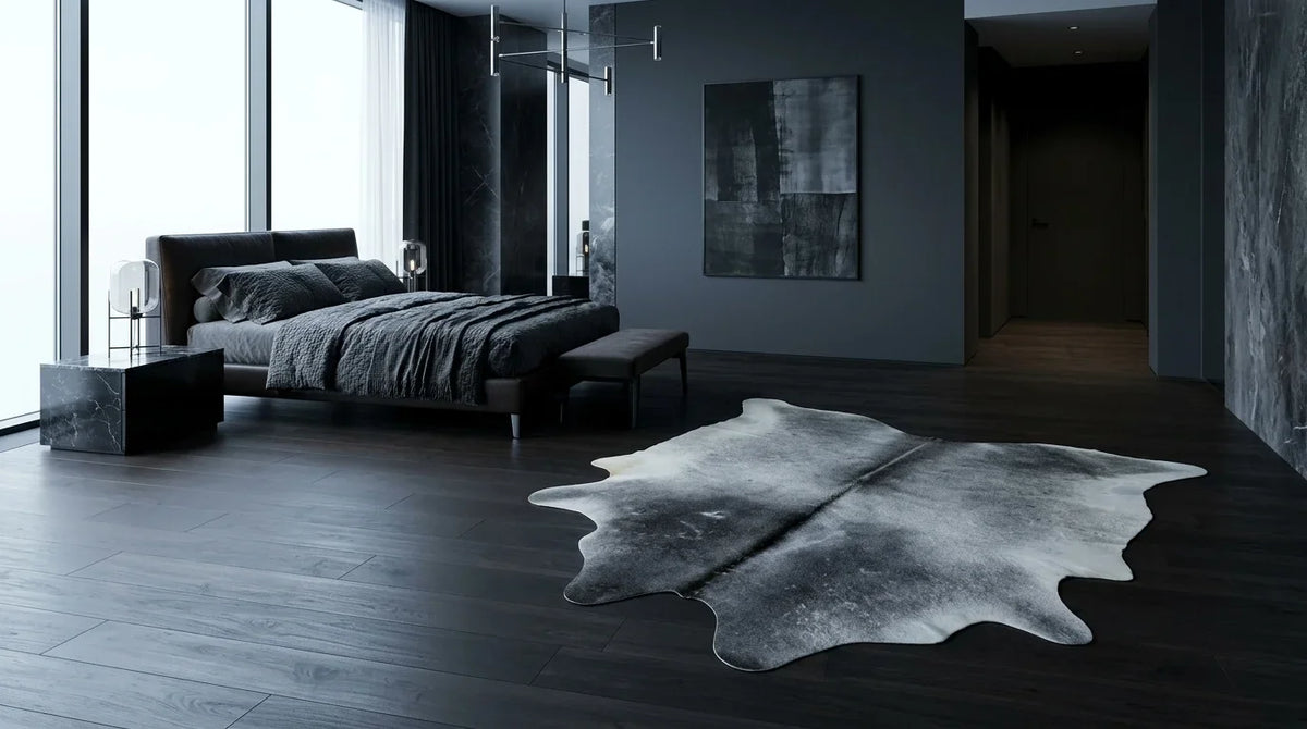 Grey cowhide rug beside bed in milano penthouse bedroom
