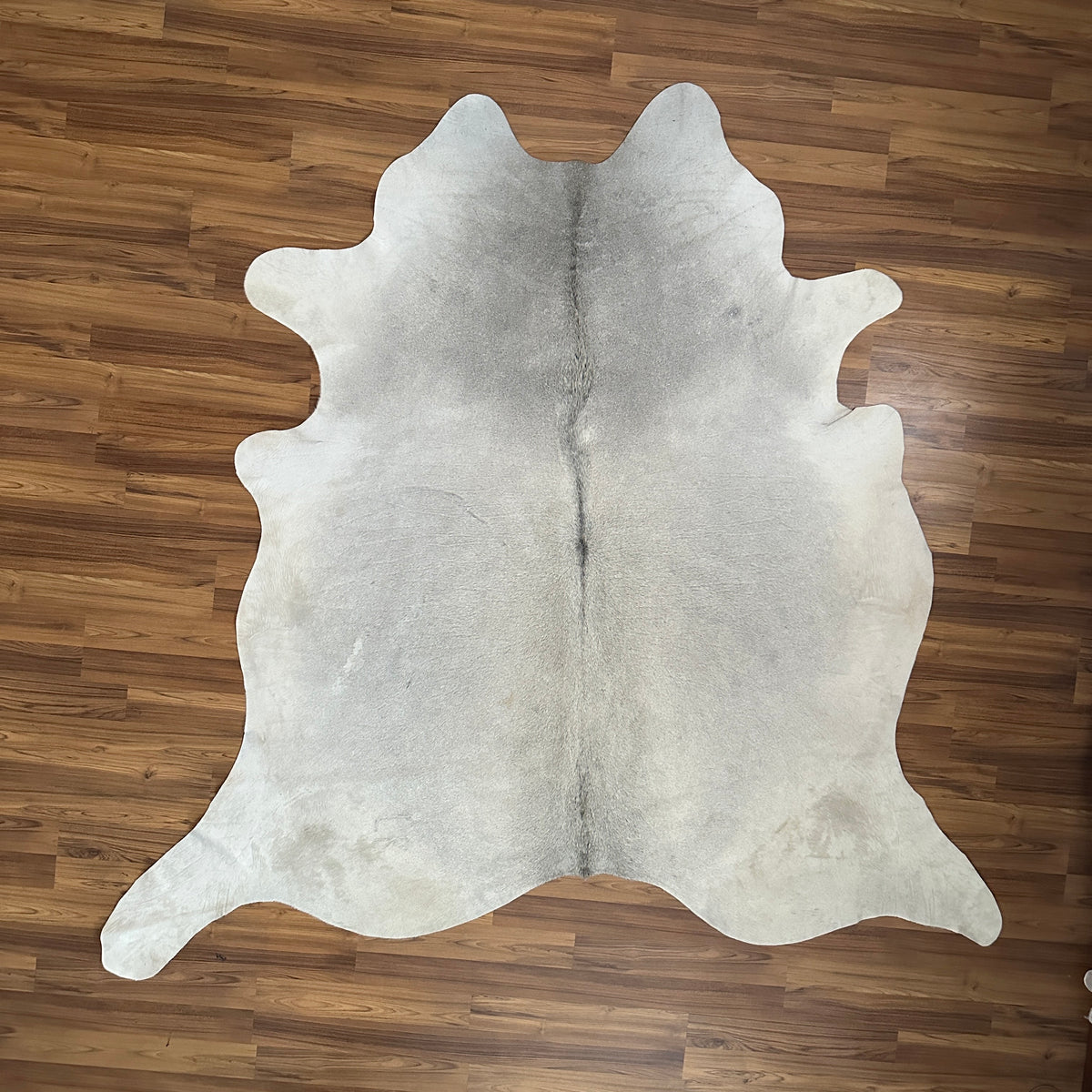 Grey cowhide rug, full overhead view — Subtle grey and white mottling with fine speckled texture throughout