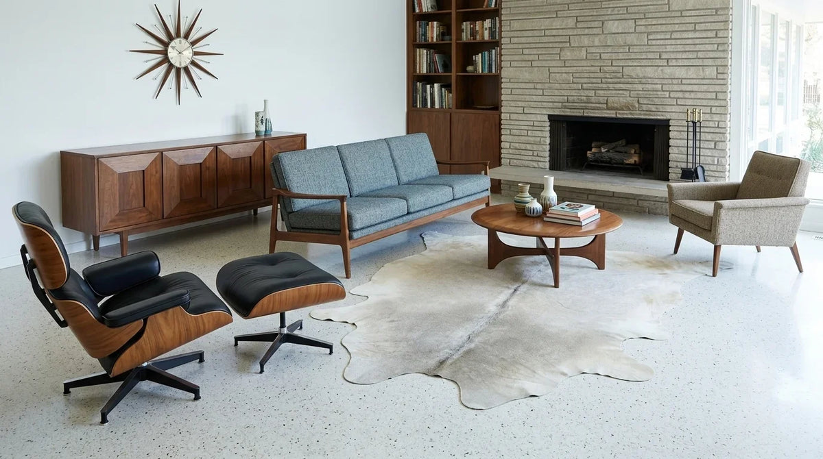 Grey cowhide rug on hardwood floor in midcentury modern living room