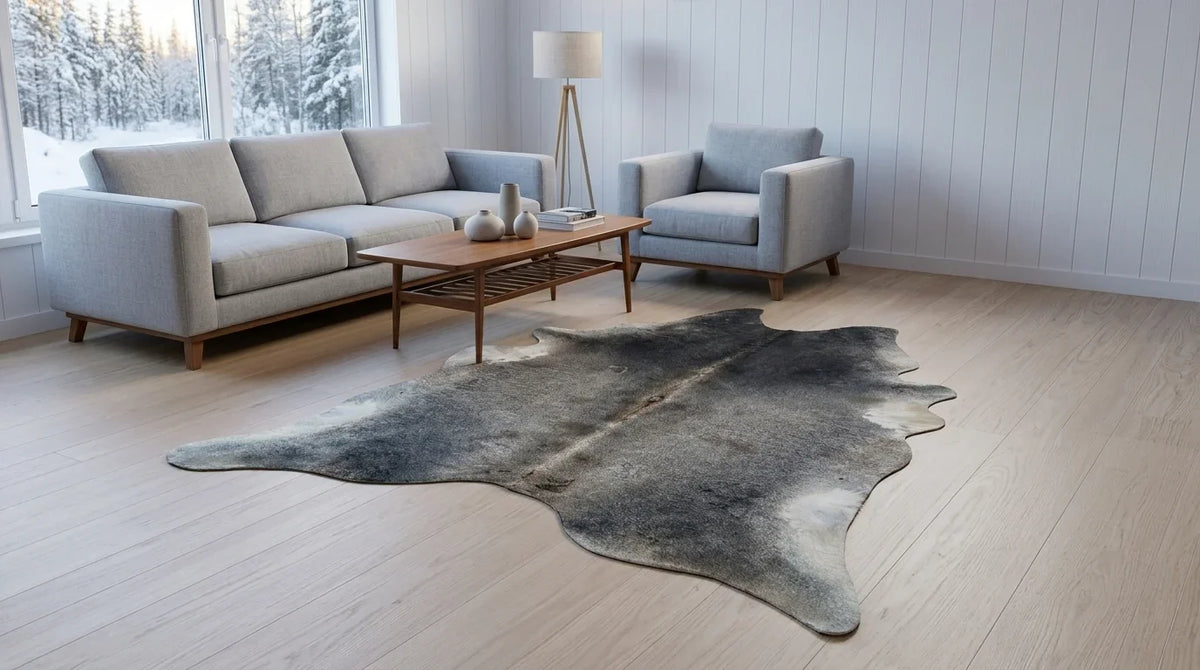 Grey cowhide rug on hardwood floor in scandinavian cabin living room