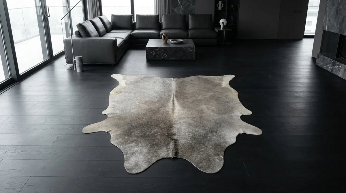 Grey cowhide rug on hardwood floor in milano penthouse living room