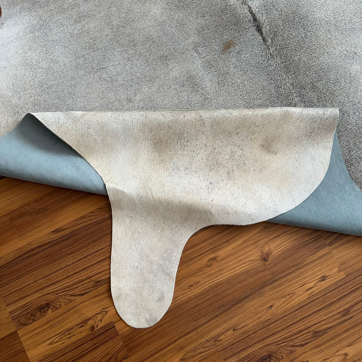 Close-up texture of Grey cowhide rug — Fine salt-and-pepper speckle with subtle darker streaking throughout