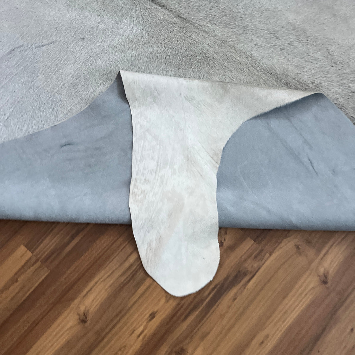 Close-up texture of Grey cowhide rug — Subtle grey and white mottling with fine speckled texture throughout