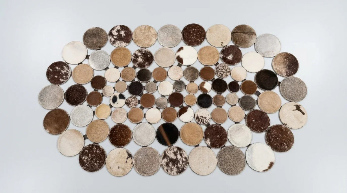 Mixed Tones round cowhide rug flat lay on white background showing round shape