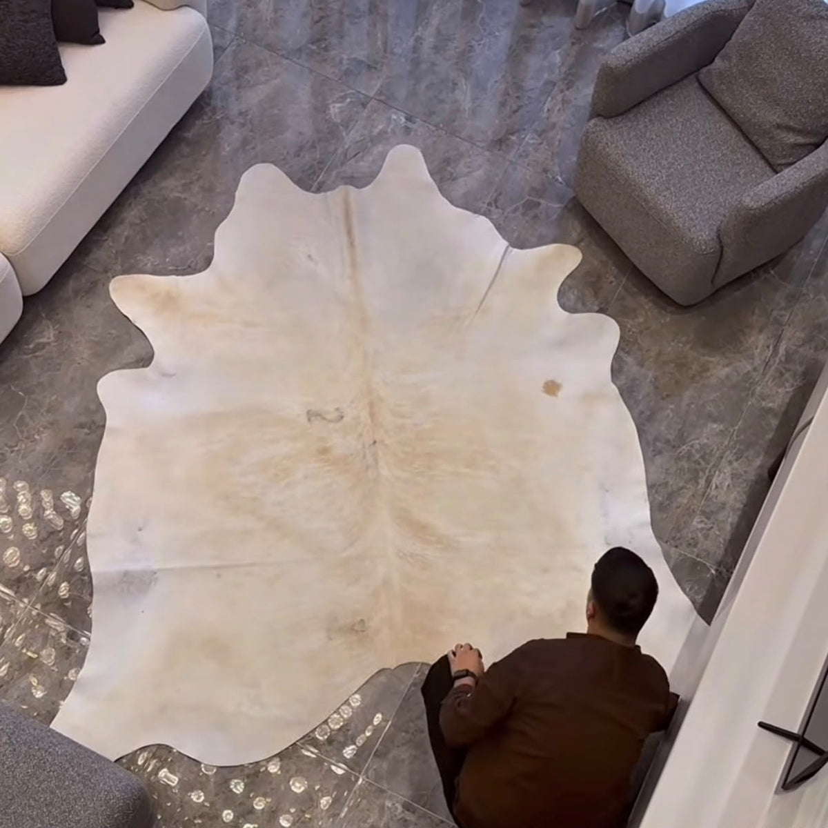 Black and white cowhide rug in a modern living room